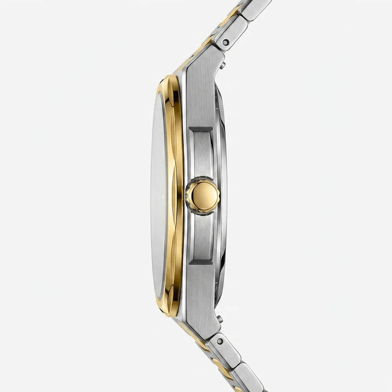 A close-up side profile of a two-tone stainless steel and gold watch with a matching metal link bracelet, set against a clean, light gray background.