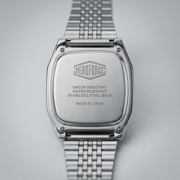 Back view of Silver digital wristwatch with rectangular face and segmented band, display showing brand “HEROFORCE"