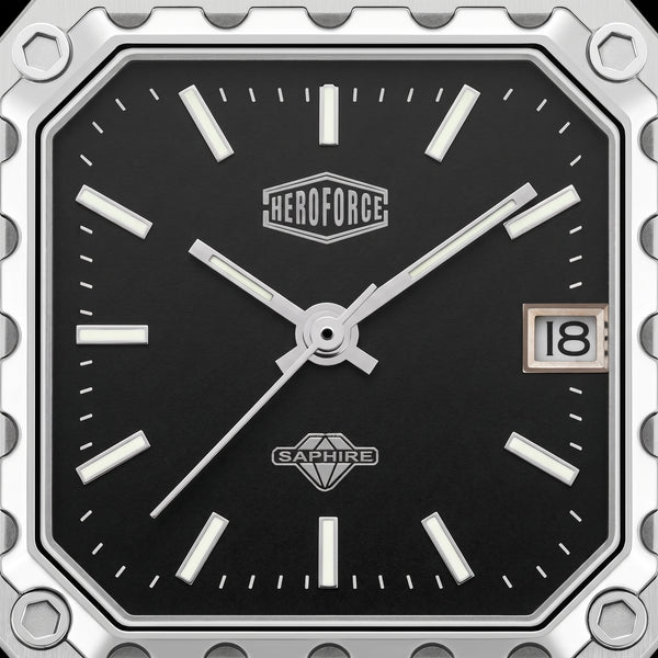 Close-up of a square analog watch face with a black dial, silver-tone hands and markers, a date window showing 18, and visible HEROFORCE and SAPWIRE branding.