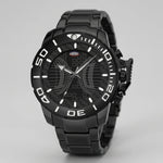 A black analog watch with a matching black metal link bracelet, featuring a textured dial with a crescent moon and grid pattern, white Arabic numerals on the bezel, and a small red and white logo on the dial.