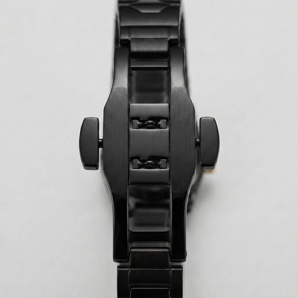 A close-up of a black metal watch band and case, showing the side crown screws and brushed and polished links, on a light gray background.