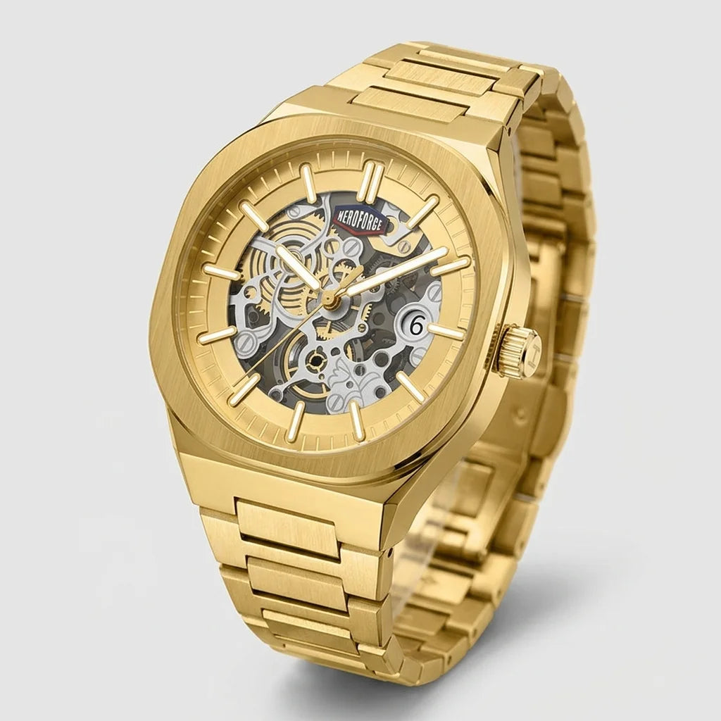 A gold-tone skeleton watch with a matching gold-tone metal link bracelet, shown on a light gray background. The watch features a transparent dial revealing the intricate mechanical movement inside.