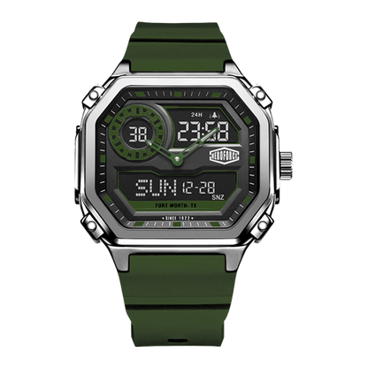 A rugged digital watch with an octagonal silver-tone metal case, a dark gray display face with green accents, and an olive green rubber strap, shown on a plain white background.