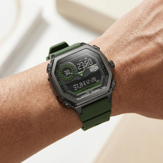 A rugged digital watch with an olive green strap and black case, worn on a person's wrist. The watch face features green and black digital displays.