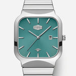 A silver-tone stainless steel wristwatch with a square bezel and a metallic teal-green dial, featuring silver stick indices, silver hands, a date window at 3 o'clock, and a matching metal link bracelet.