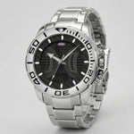A silver stainless steel wrist watch with a black dial, featuring a rotating bezel and a metallic link bracelet, shown on a light gray background.