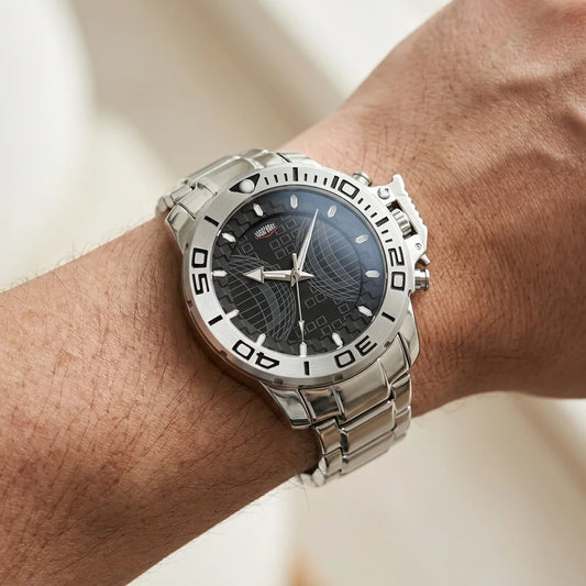 A silver stainless steel wristwatch with a black dial and bezel, worn on a person's wrist.
