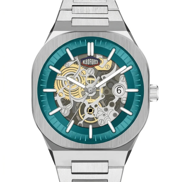 A stainless steel skeleton wristwatch with a teal blue inner dial ring and a visible gold and silver mechanical movement through the open dial.