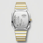 A two-tone stainless steel and gold wristwatch shown from the back, featuring a square case and a striped metal bracelet on a light gray background.