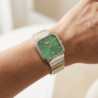 A wristwatch with a green square dial and a two-tone silver and gold metal link bracelet, shown worn on a person's wrist.