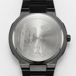 Back view of A men's analog watch with a black metal case and link bracelet, featuring a silver dial with a wavy pattern, silver hour markers