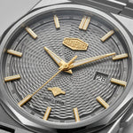 Close-up of a HEROFORCE men's watch featuring a textured gray dial, gold-tone hands and hour markers, and a silver-tone stainless steel case.