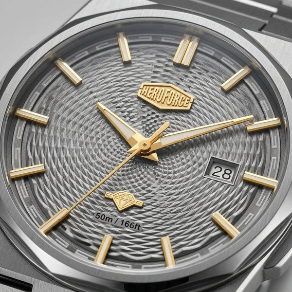 Close-up of a HEROFORCE men's watch featuring a textured gray dial, gold-tone hands and hour markers, and a silver-tone stainless steel case.