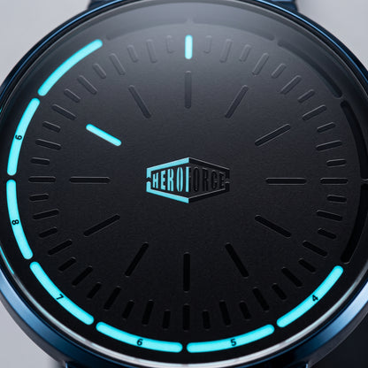 Close-up of a black dial watch face with glowing cyan hour markers and hands, plus a centered HEROFORCE logo.