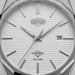 Close-up of a silver-toned watch dial with a white textured face, angular metal hour markers, silver hands, a date window showing 28, and the Heroforce logo at the top center.