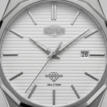 Close-up of a silver-toned watch dial with a white textured face, angular metal hour markers, silver hands, a date window showing 28, and the Heroforce logo at the top center.