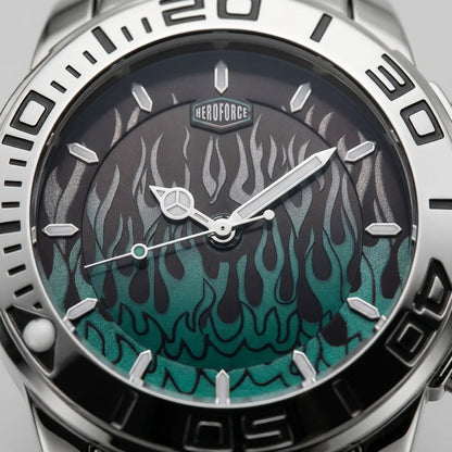 Close-up of a wristwatch dial and bezel with a silver stainless steel case, black outer ring, and a dark dial featuring a teal-to-black flame pattern. The brand name HEROFORCE is visible above the 12 o'clock mark.