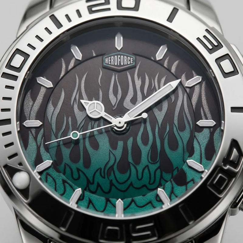 Close-up of a wristwatch dial and bezel with a silver stainless steel case, black outer ring, and a dark dial featuring a teal-to-black flame pattern. The brand name HEROFORCE is visible above the 12 o'clock mark.