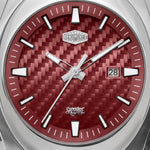 Close-up of a wristwatch dial with a silver-toned bezel, a red woven-texture face, white hour markers, silver hands, and a date window showing 28.
