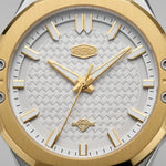 Close-up of men's watch featuring a brushed gold octagonal bezel, a white textured dial with gold hour markers and hands, and a Sapphire crystal.