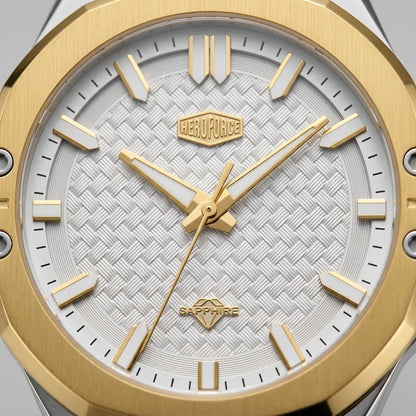 Close-up of men's watch featuring a brushed gold octagonal bezel, a white textured dial with gold hour markers and hands, and a Sapphire crystal.