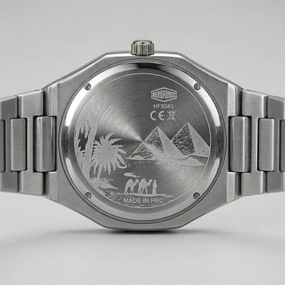 Close-up of the back of a stainless steel wristwatch with a metal link bracelet. 