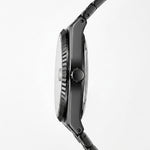 Close-up side profile of a black analog watch with a textured bezel, round crown, and matching black link band on a light gray background.