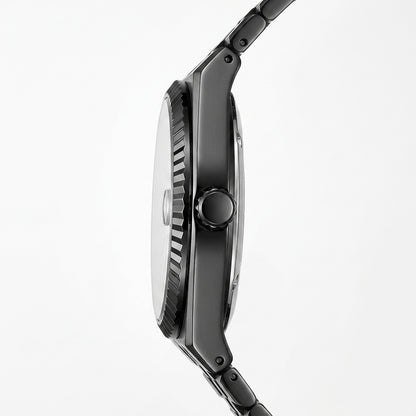 Close-up side profile of a black analog watch with a textured bezel, round crown, and matching black link band on a light gray background.