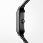Close-up side profile of a black smartwatch with a glossy rectangular face and matching black metal link band, shown against a clean white background.