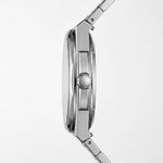 Close-up side profile of a stainless steel watch with a matching metal link band, showing the case, crown, and part of the bracelet on a light gray background.
