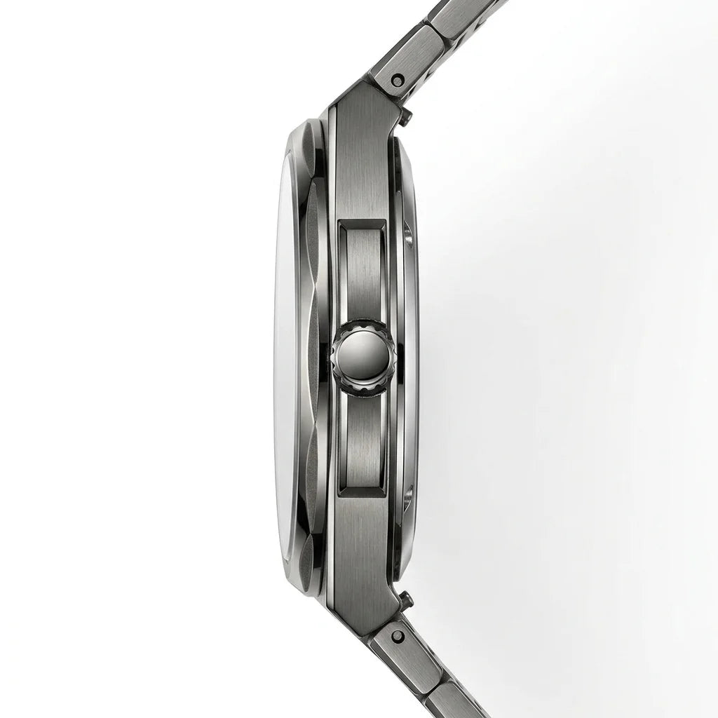 Close-up side profile of a stainless steel watch with a brushed metal case and integrated link band on a white background.