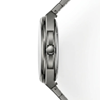 Close-up side profile of a stainless steel watch with a brushed metal case and integrated link band on a white background.