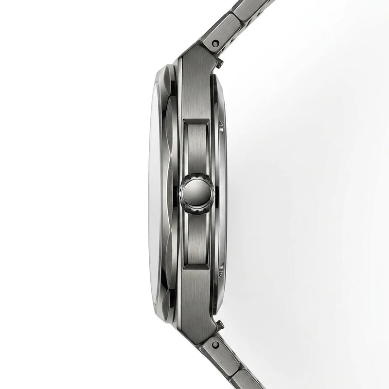 Close-up side profile of a stainless steel watch with a brushed metal case and integrated link band on a white background.