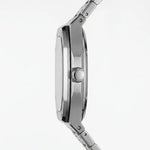 Close-up side profile of a stainless steel watch with a teal dial on a clean white background.