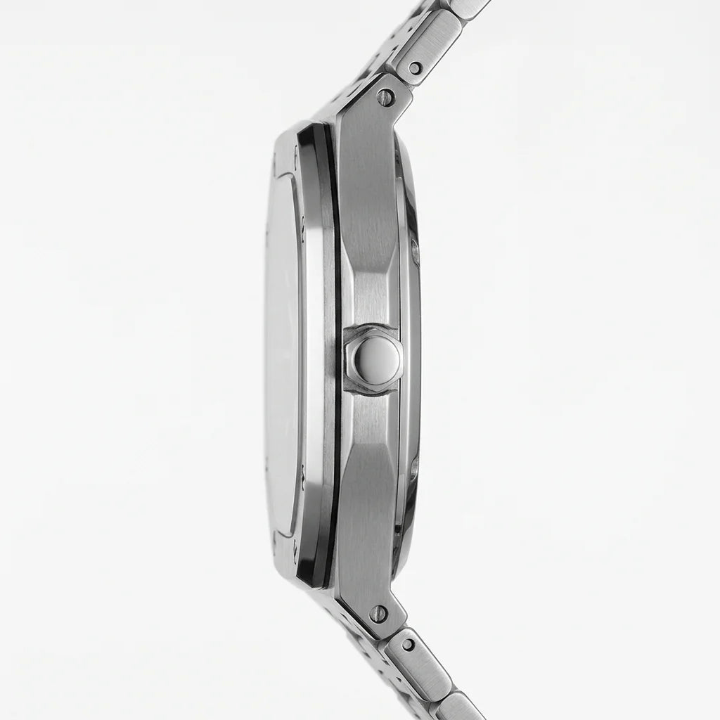 Close-up side profile of a stainless steel watch with a teal dial on a clean white background.