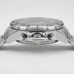 Close-up side view of a stainless steel wristwatch with a silver dial, textured bezel, and matching metal bracelet on a light gray background.