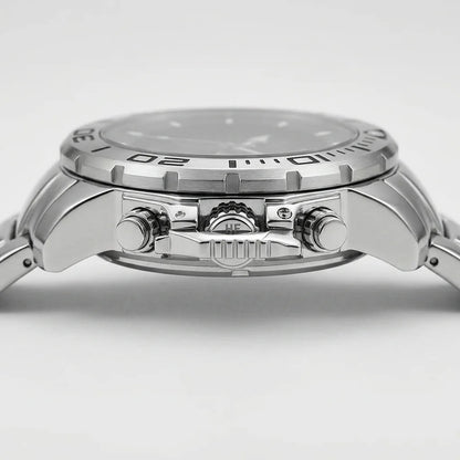 Close-up side view of a stainless steel wristwatch with a silver dial, textured bezel, and matching metal bracelet on a light gray background.