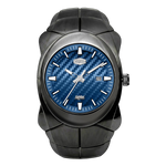 A rugged black watch with a textured blue carbon-fiber-style dial, silver-tone hands and markers, and a date window.