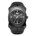 A rugged black watch with a carbon fiber textured dial, silver-tone hands and indices, and a black segmented strap.
