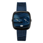 A modern square analog watch with a black bezel, a blue patterned dial, and a dark blue textured strap.