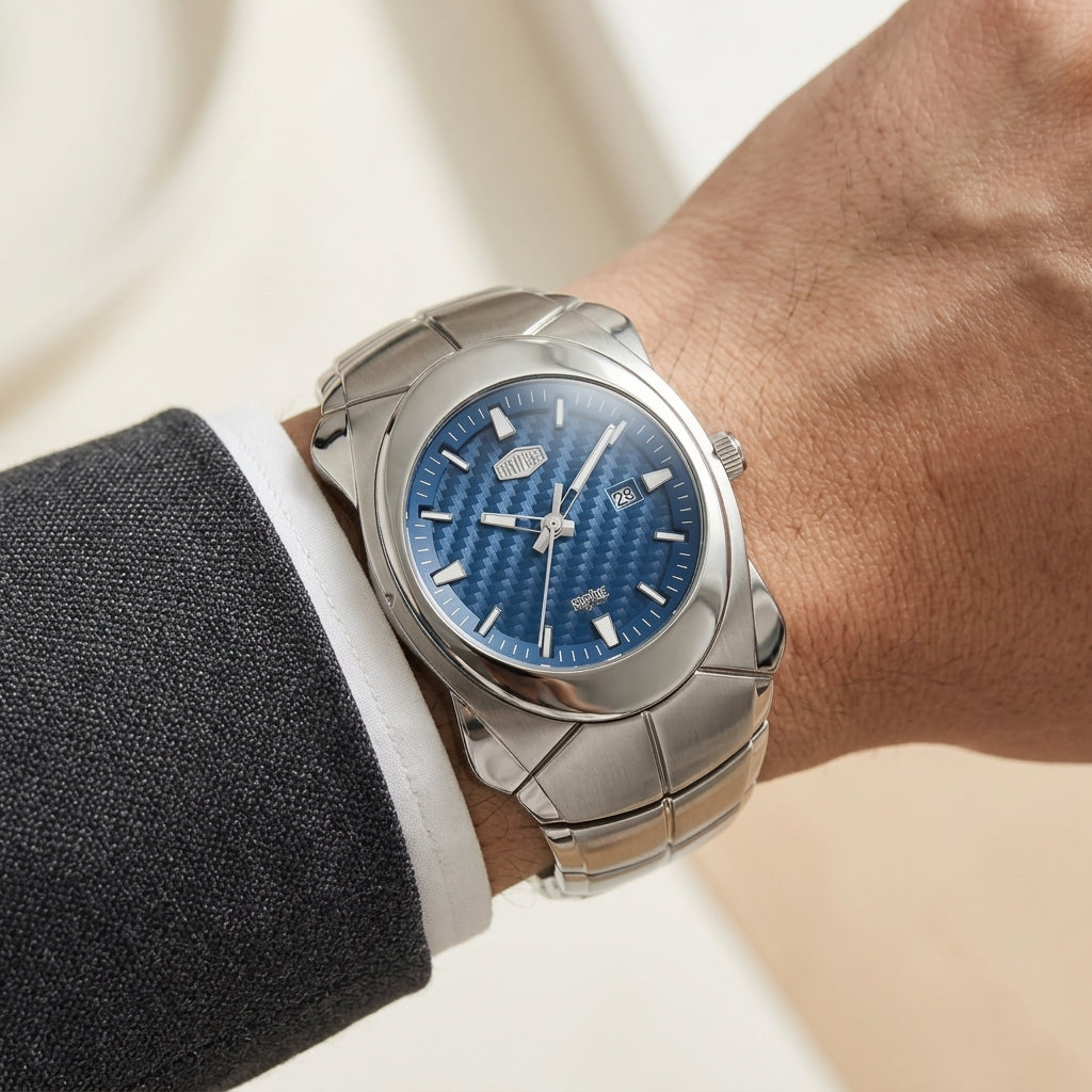 A silver stainless steel wristwatch with a textured blue dial, shown worn on a person's wrist.