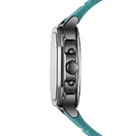 Side profile of Rectangular wristwatch with metallic case, turquoise strap, and geometric analog-digital face with turquoise accents.