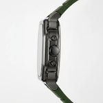Side profile of a rugged smartwatch with a dark metallic case and an olive green strap, shown against a plain white background.