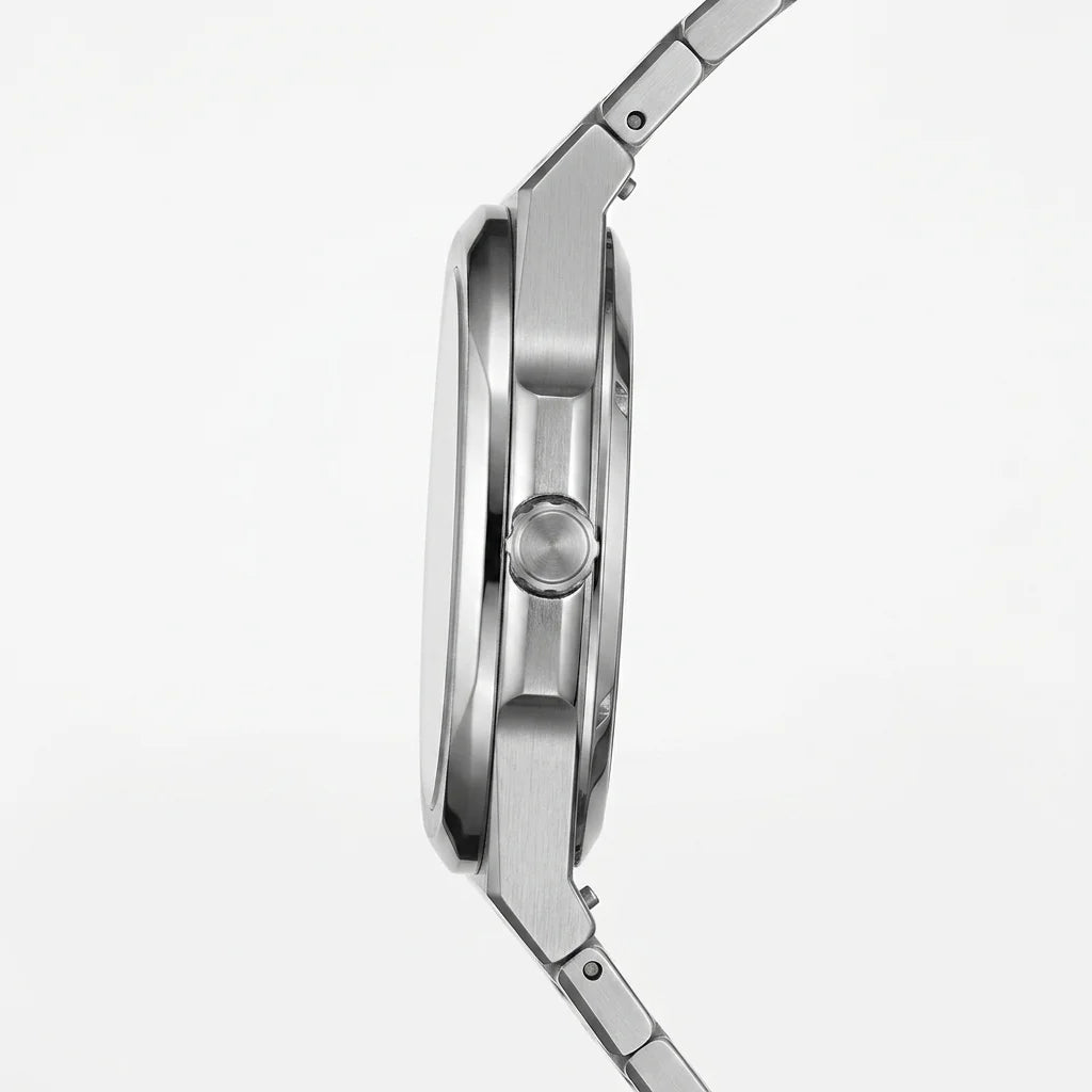 Side profile view - Stainless steel wristwatch with turquoise sunburst dial, silver markers, and small seconds subdial