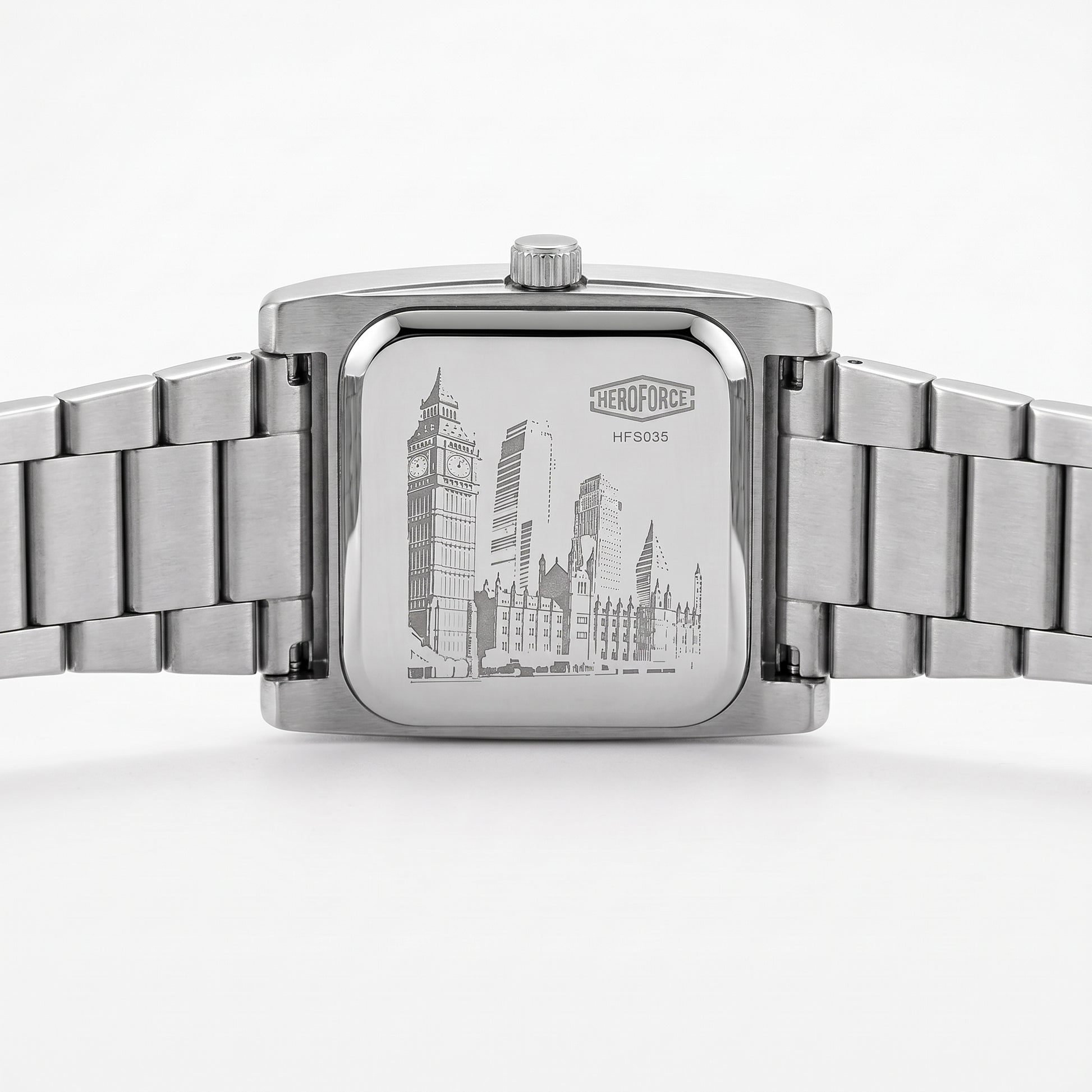 Silver stainless steel wrist watch with a square case and integrated metal link bracelet, shown from the back.
