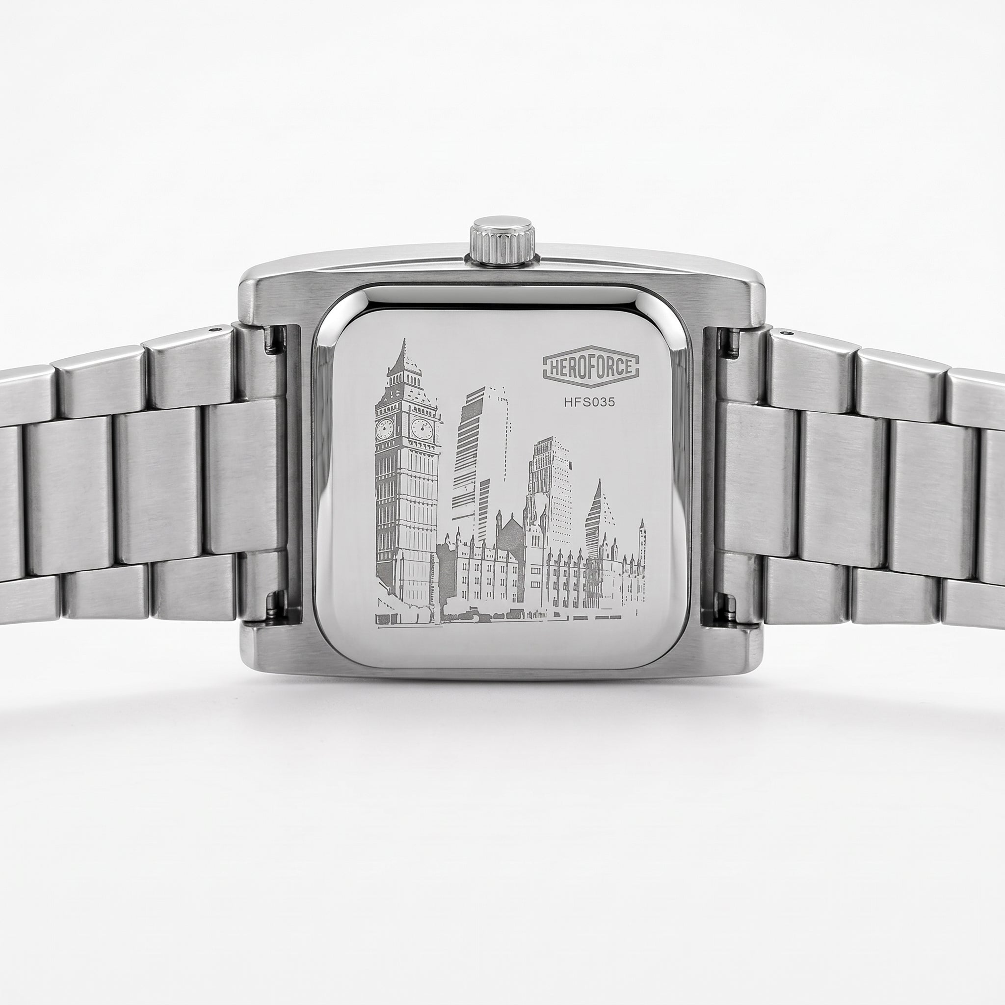 Silver stainless steel wrist watch with a square case and integrated metal link bracelet, shown from the back.