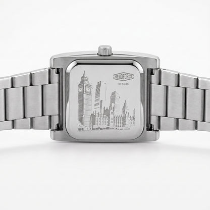 Silver stainless steel wrist watch with a square case and integrated metal link bracelet, shown from the back.