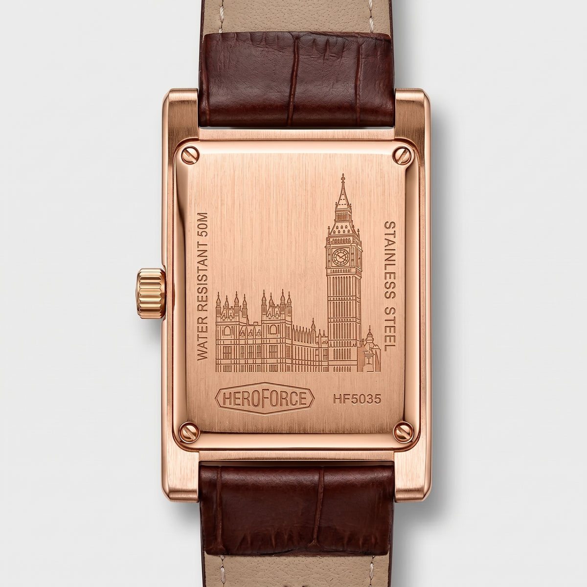 The back of a rectangular rose gold watch with a brown leather strap