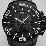 Upclose macro view of Black stainless steel watch with black geometric dial, oversized bezel, and metal bracelet