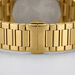 Upclose strap of Gold-tone stainless steel watch with green textured dial, date display, and integrated bracelet
